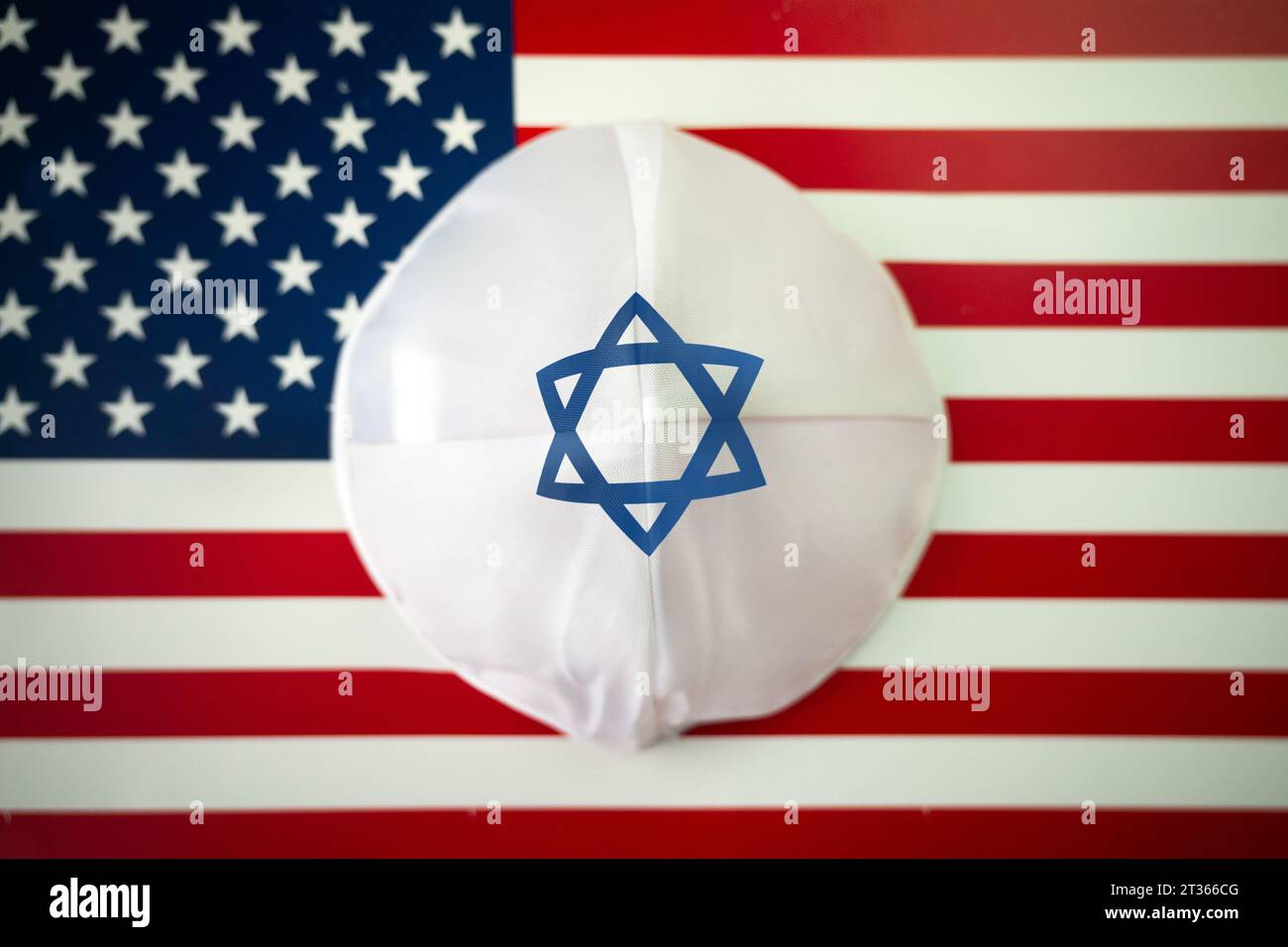 Israeli kippah on the US flag. The Jewish community in the country. Stock Photo