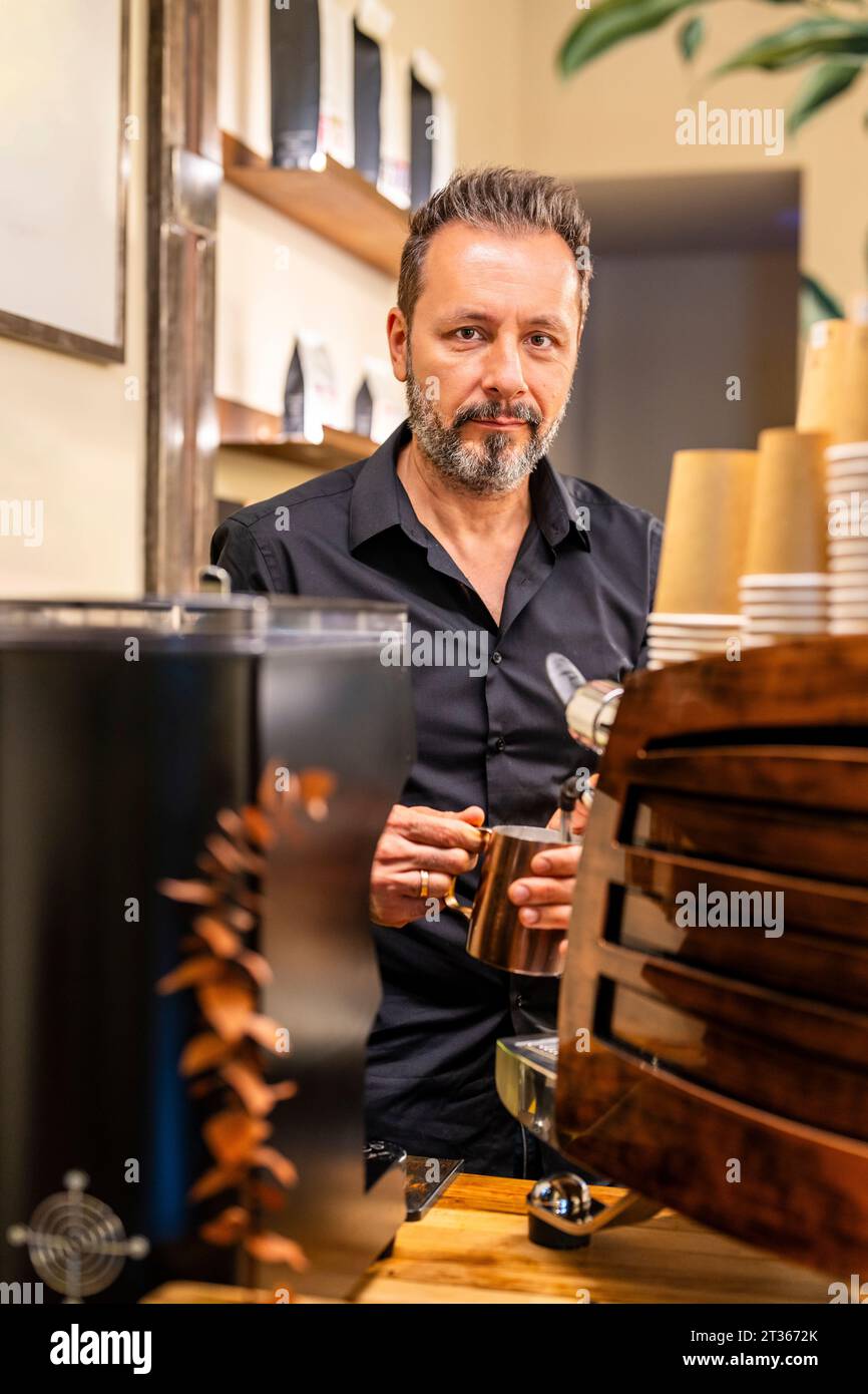 Barista preparing coffee in cafe Stock Photo