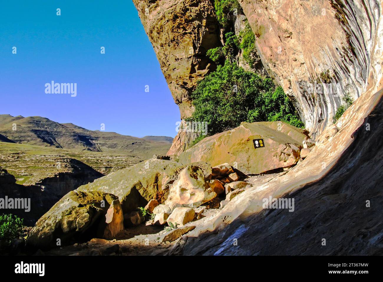 Hiking route markers in an overhand in the Drakensberg Mountains of South Africa Stock Photo