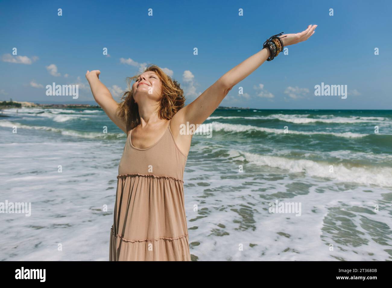 Woman standing sea raised arms hi-res stock photography and images - Alamy