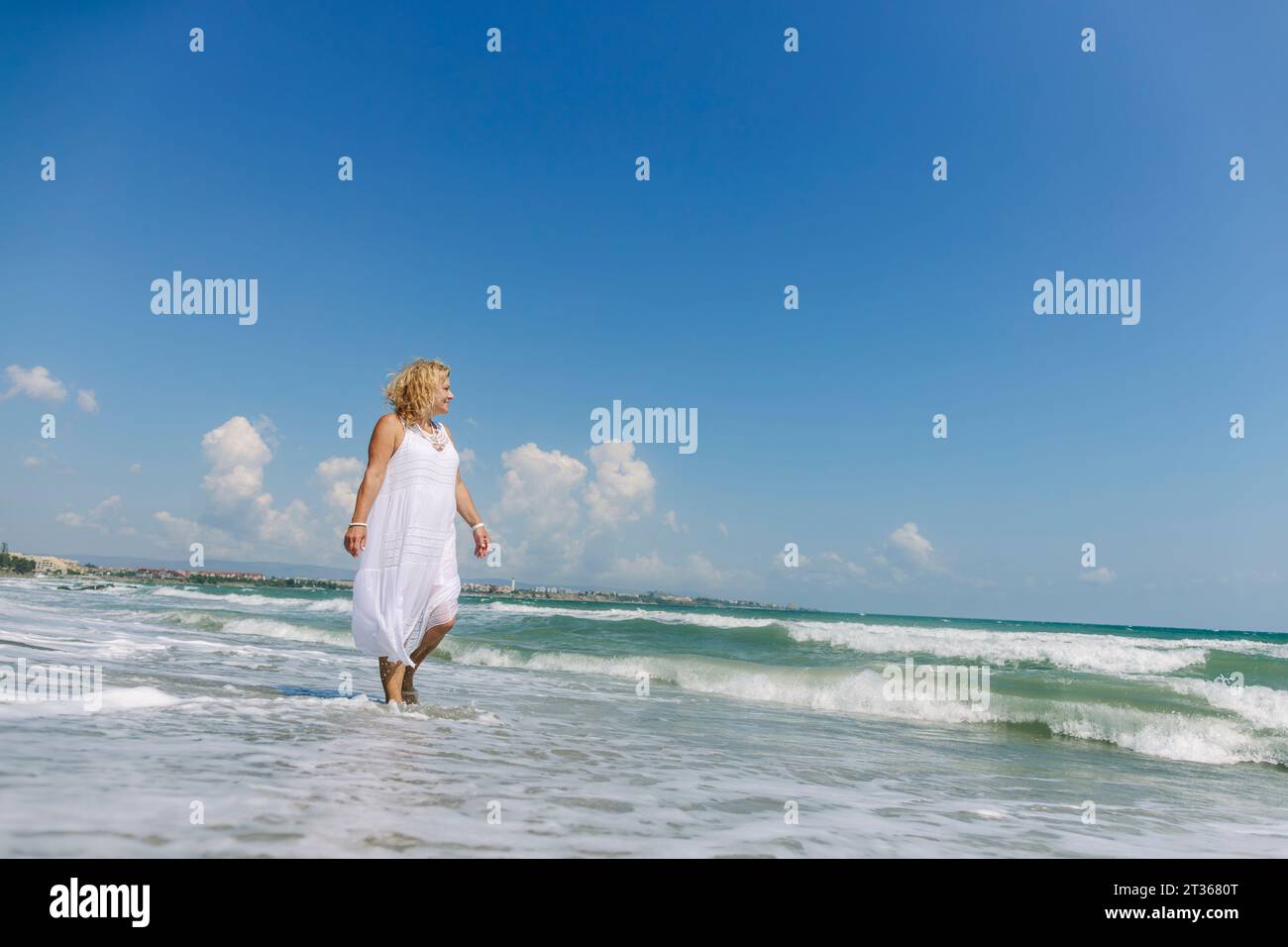 Senior woman walking beach hi-res stock photography and images - Alamy