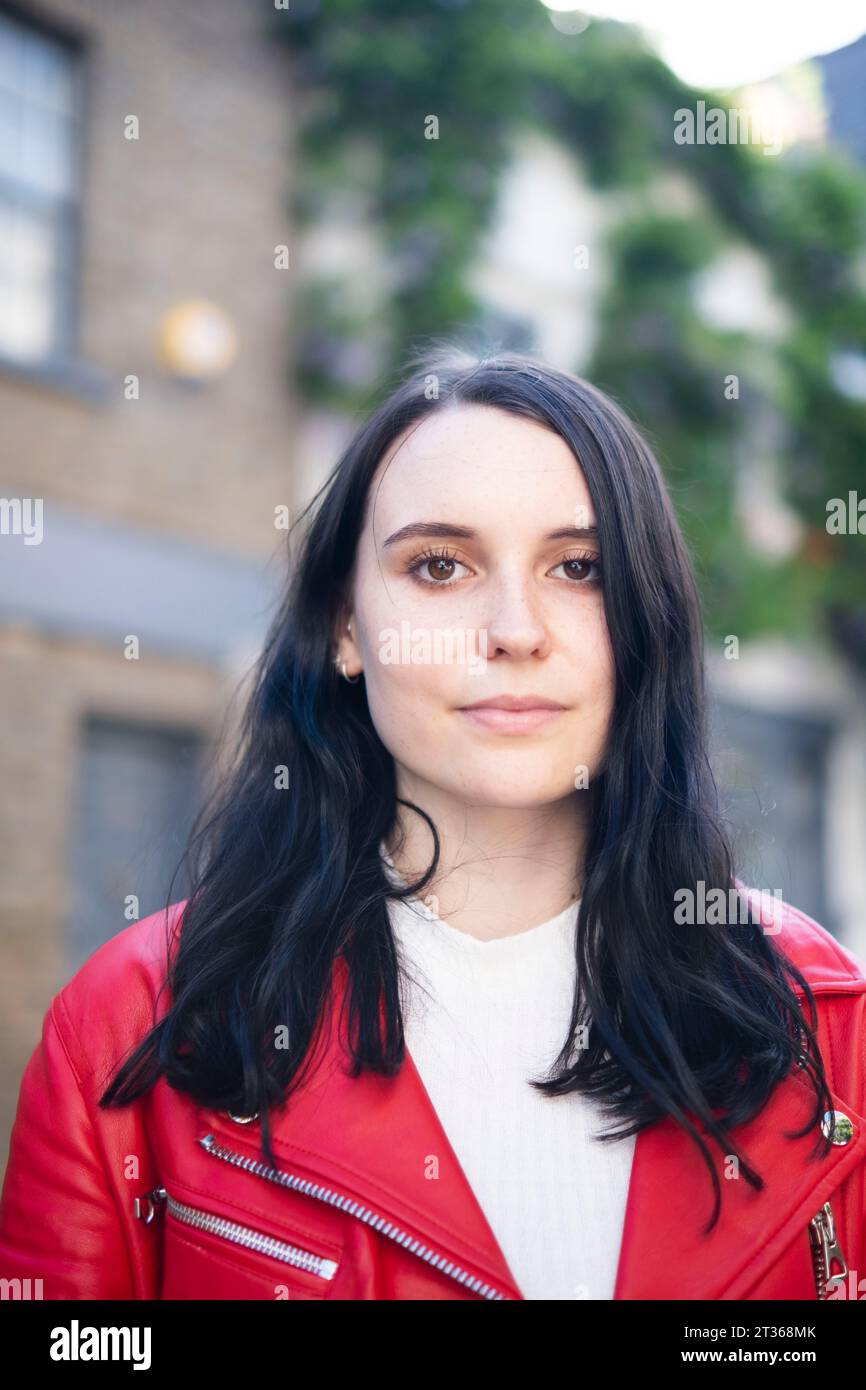 Smiling young woman with black hair Stock Photo