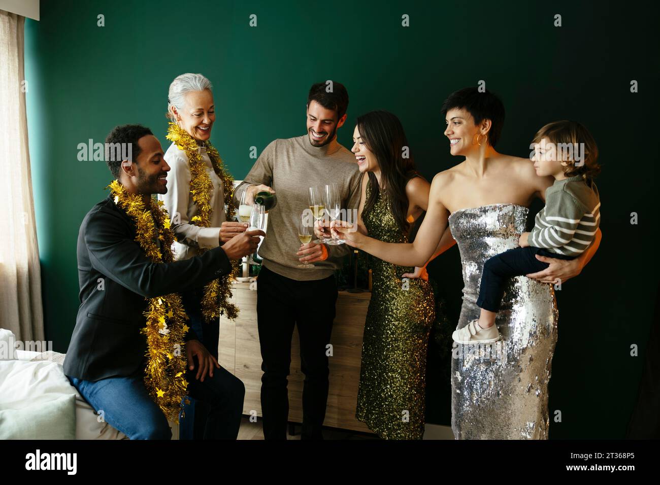 Multi-ethnic family toasting champagne glasses at home Stock Photo