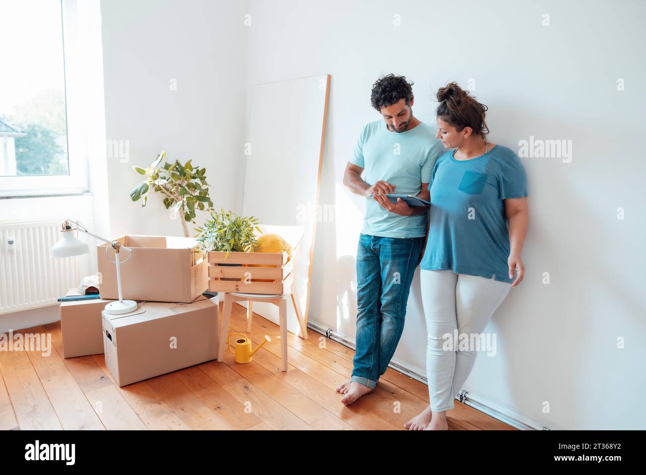 Woman with man using tablet PC at home Stock Photo