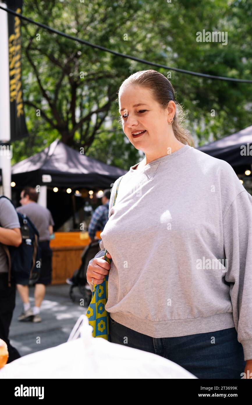 Woman wearing gray sweatshirt hi-res stock photography and images - Alamy