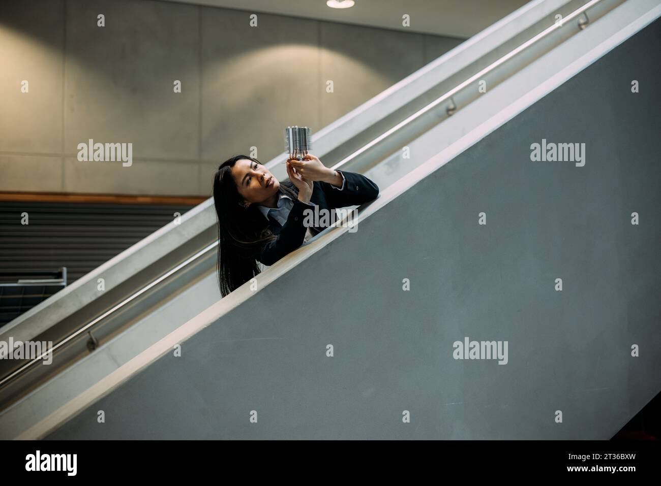 Engineer analyzing cooling module at staircase in office Stock Photo