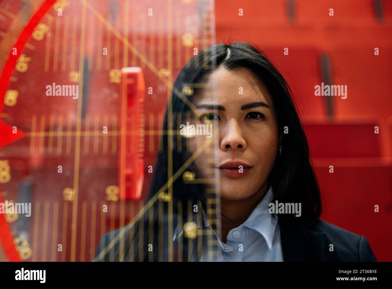 Businesswoman with large protractor in convention center Stock Photo