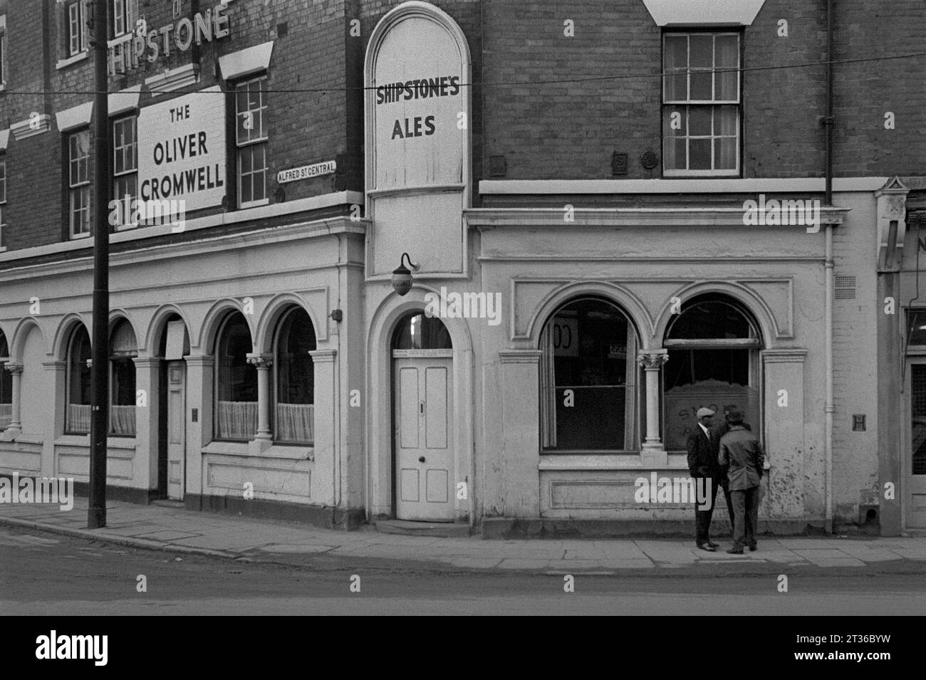 Group of men outside the Oliver Cromwell public house, St Ann's Well Road, during the slum clearance and demolition of St Ann's, Nottingham. 1969-1972 Stock Photo