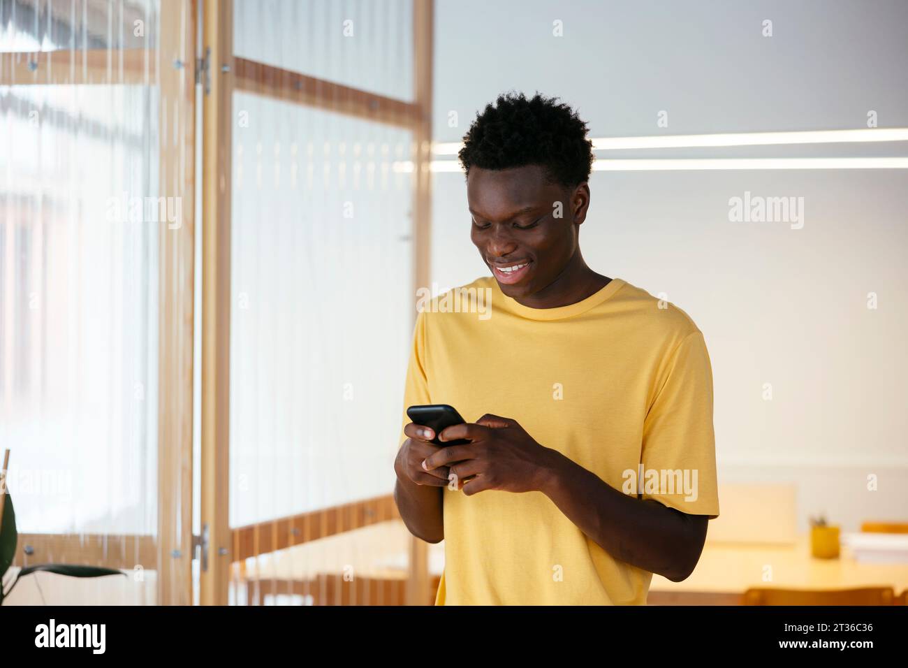 Happy student using smart phone at university Stock Photo