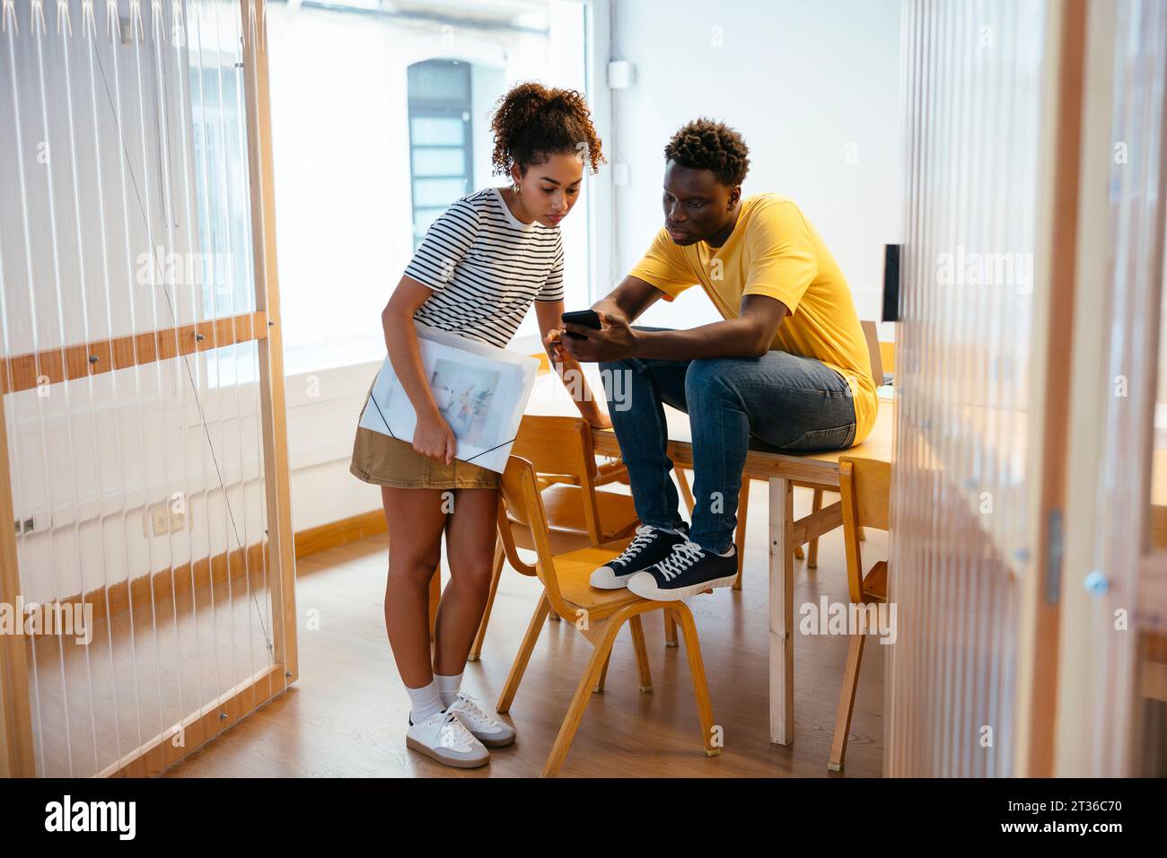 Students using smart phone at university Stock Photo