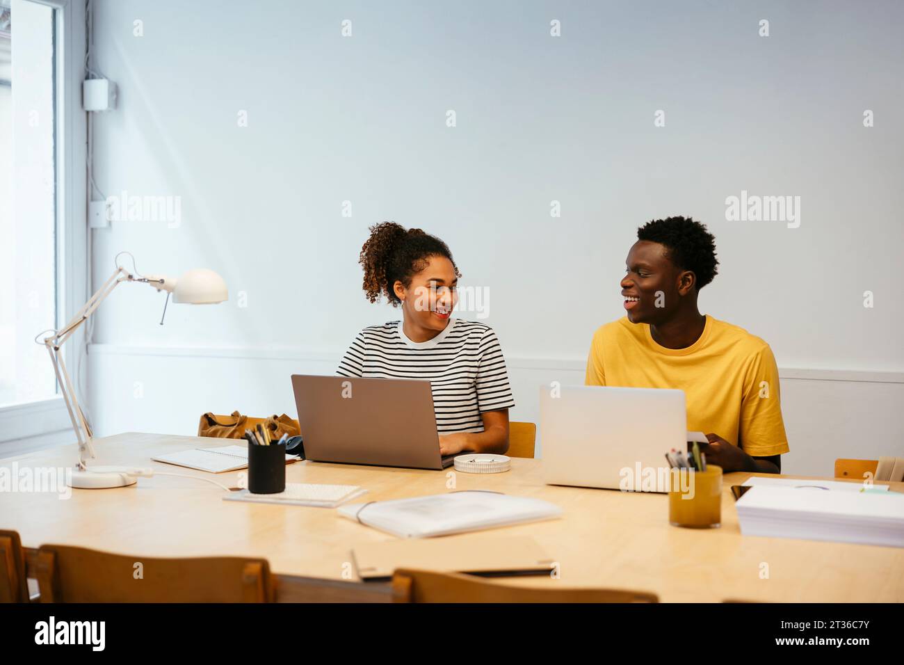 Happy young students studying together at university Stock Photo