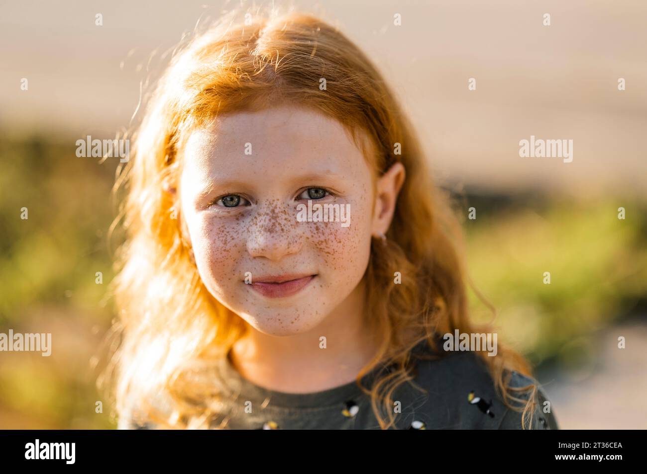 Smiling redhead girl with freckles Stock Photo