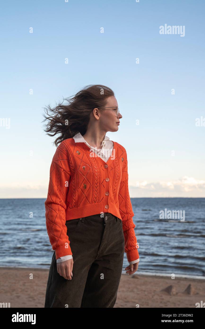 Young woman standing at beach Stock Photo