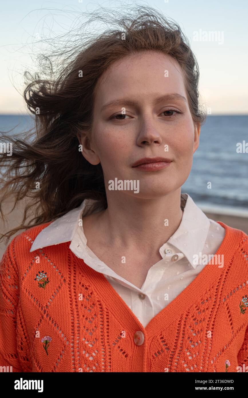 Woman wearing orange sweater hi-res stock photography and images - Alamy