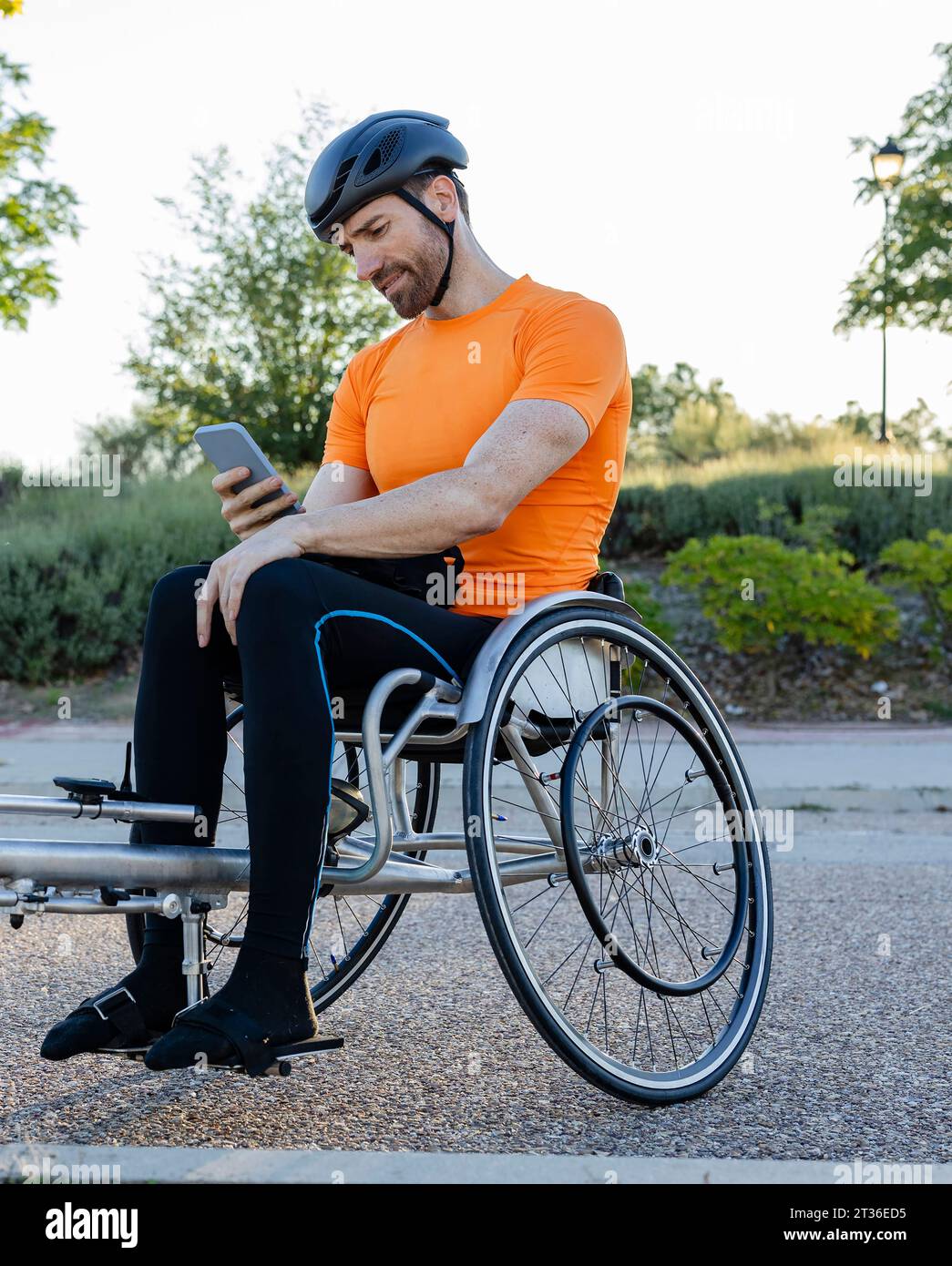 Mature man using smart phone sitting on wheelchair Stock Photo