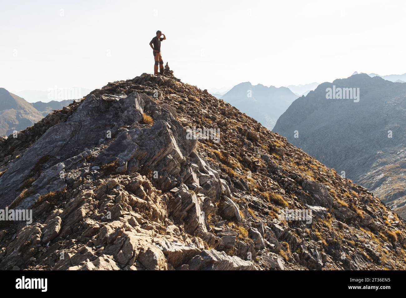Man standing mountain light sky hi-res stock photography and images - Alamy