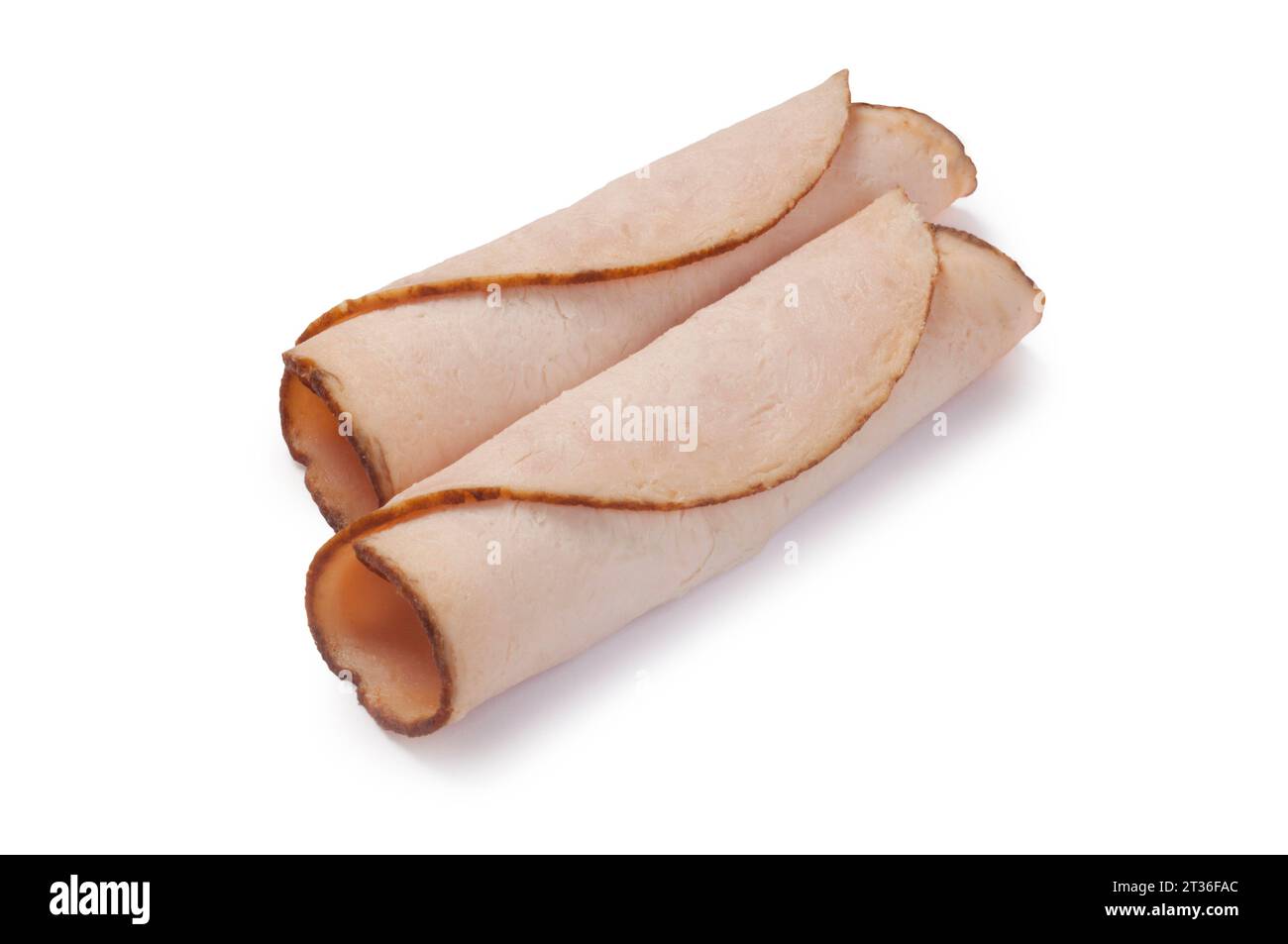 Studio shot of sliced turkey roll cut out against a white background - John Gollop Stock Photo