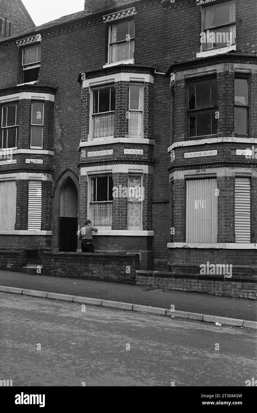 Row of bay windowed terraced houses with ornate brickwork awaiting