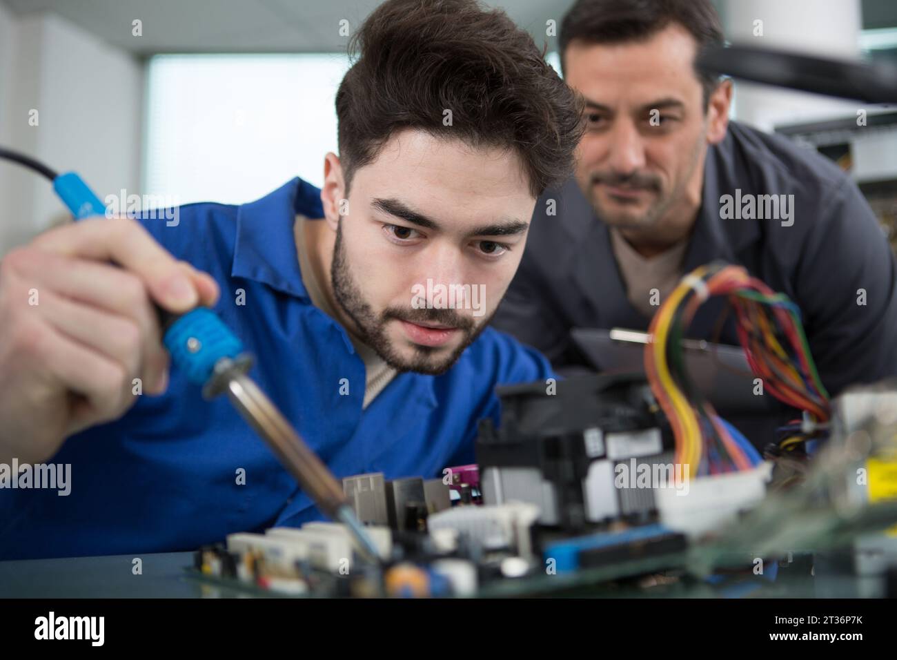 teacher with student in metallurgy Stock Photo Alamy