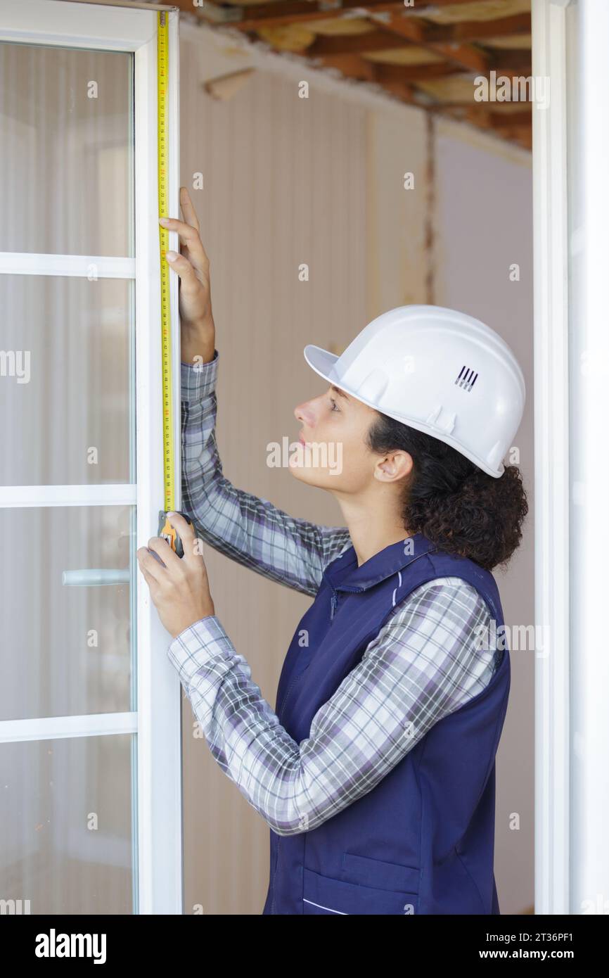 woman measuring window frame Stock Photo - Alamy