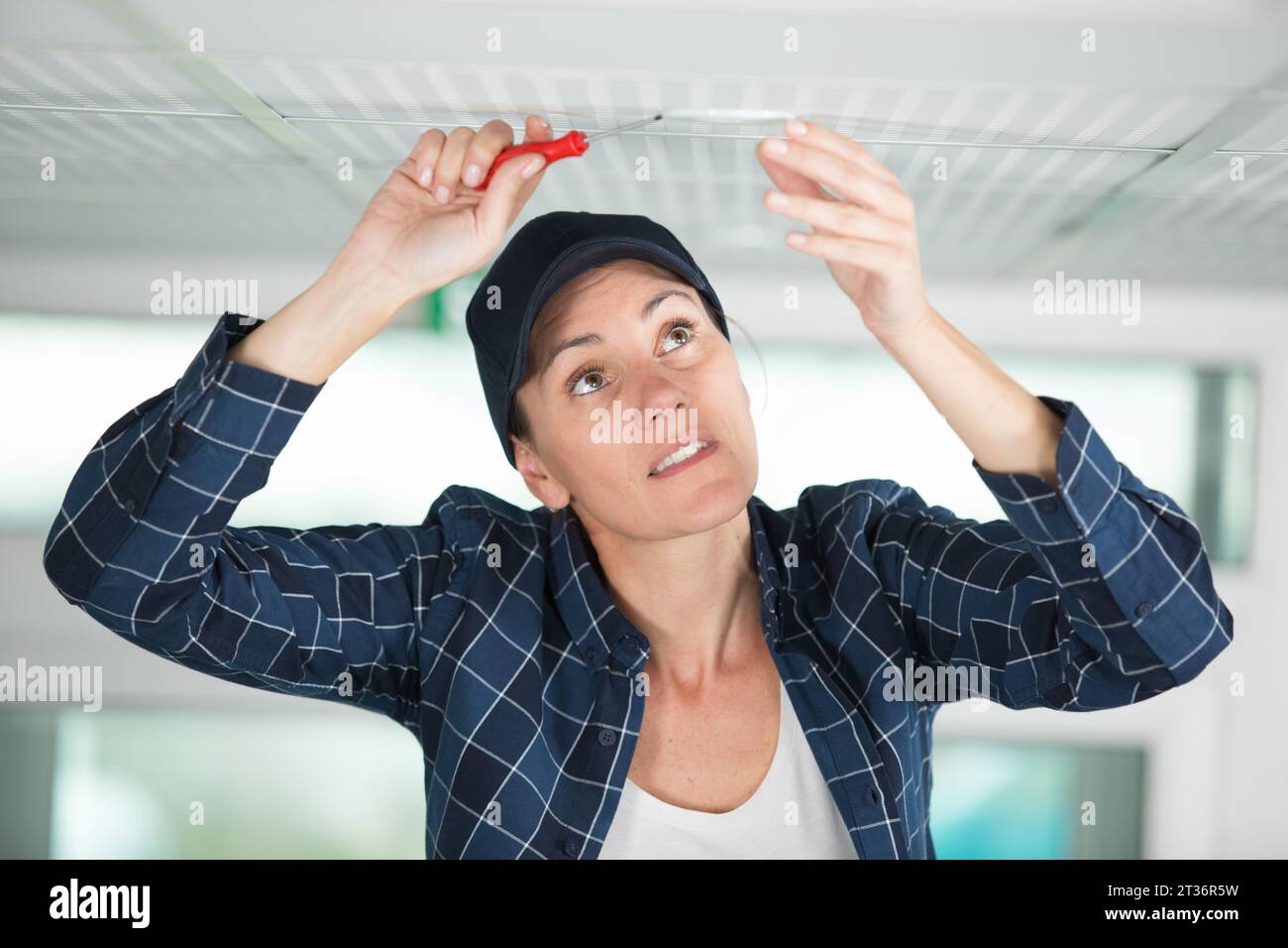 Worker ceiling panel ladder hi-res stock photography and images - Alamy