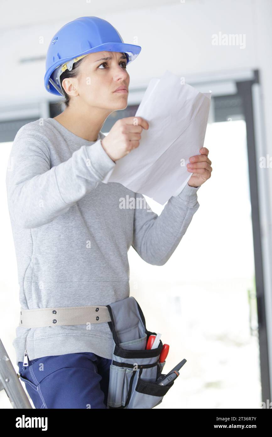 female construction engineer holding blueprint at site Stock Photo - Alamy