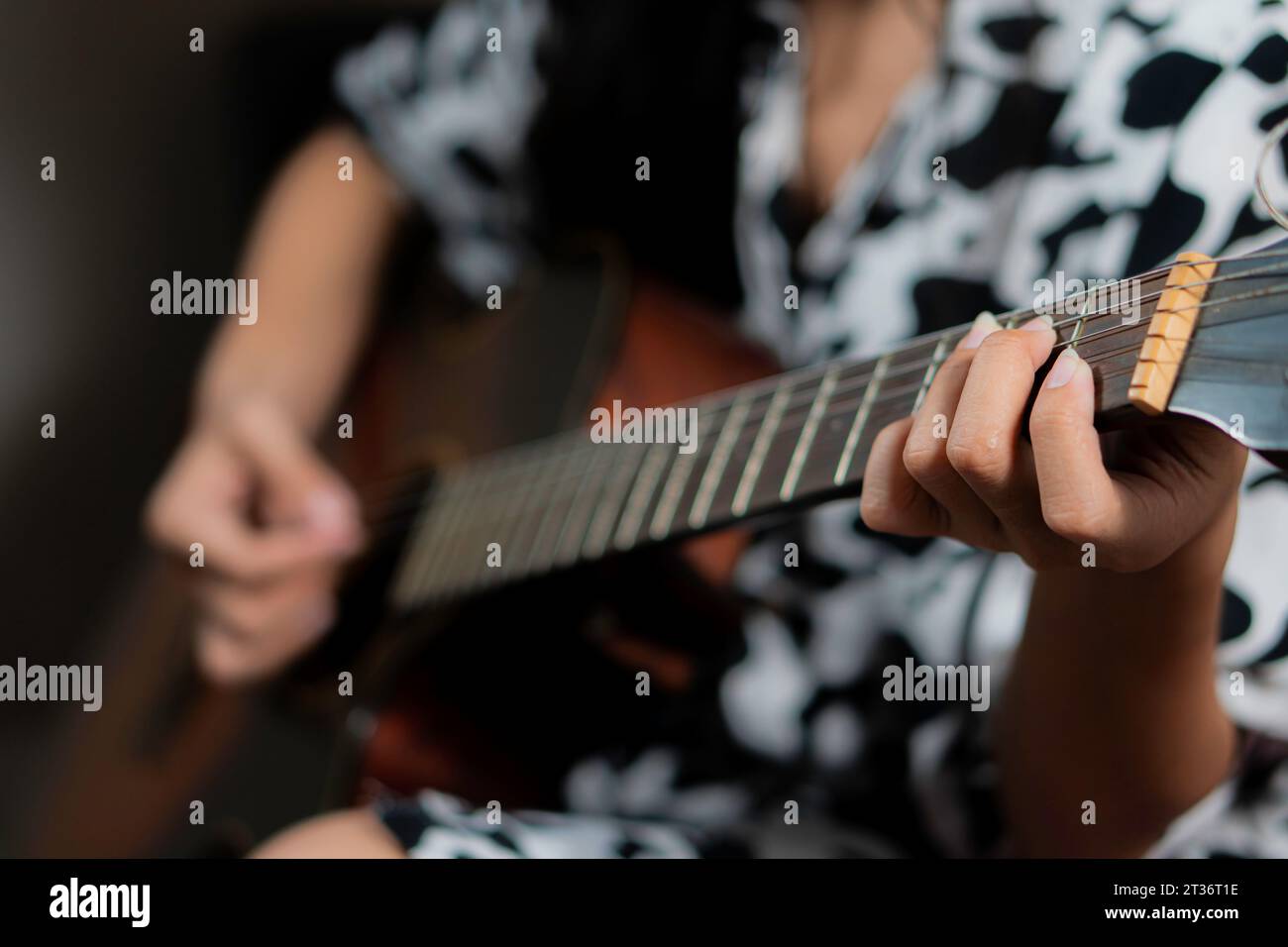 Young woman playing acoustic guitar Stock Photo - Alamy