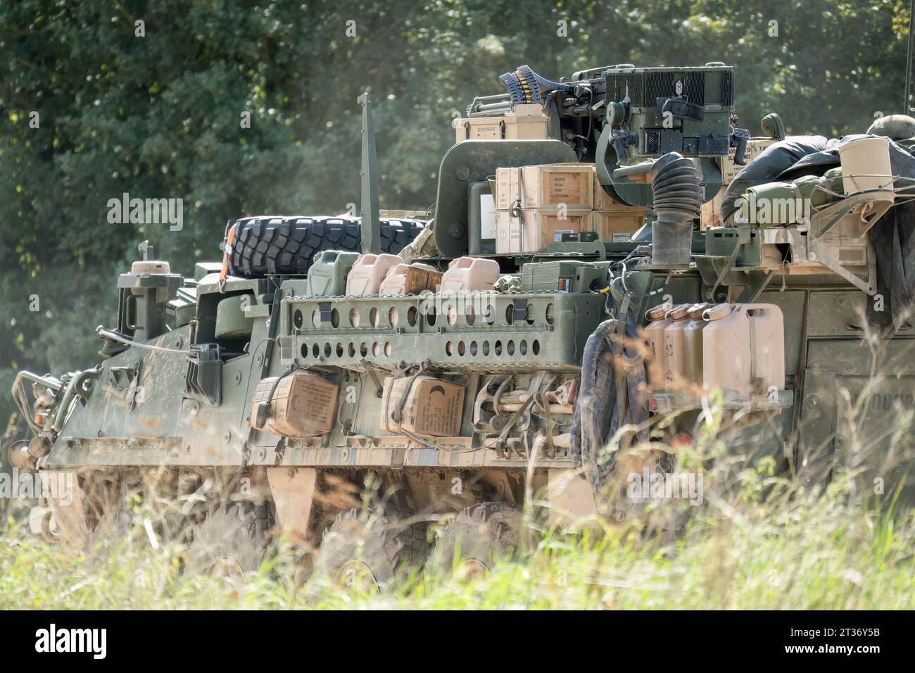 heavily laden USA Stryker 8-wheeled fighting vehicle in motion Stock Photo