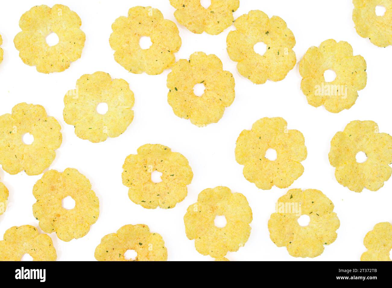 Full background of flower shaped salty and crispy peanut snack isolated Stock Photo