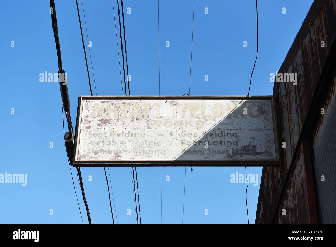 LONG BEACH, CALIFORNIA - 18 OCT 2023: Faded and rusty sign on the Whyatt Welding Works building . Stock Photo