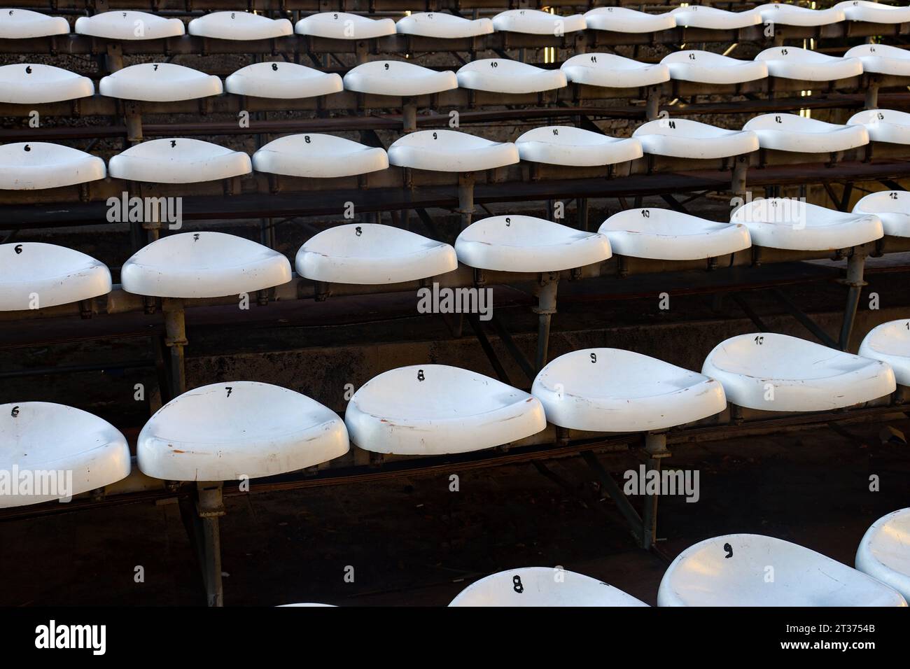 Multiple rows of white outdoor amphitheater seats for open-air ceremonies close-up Stock Photo