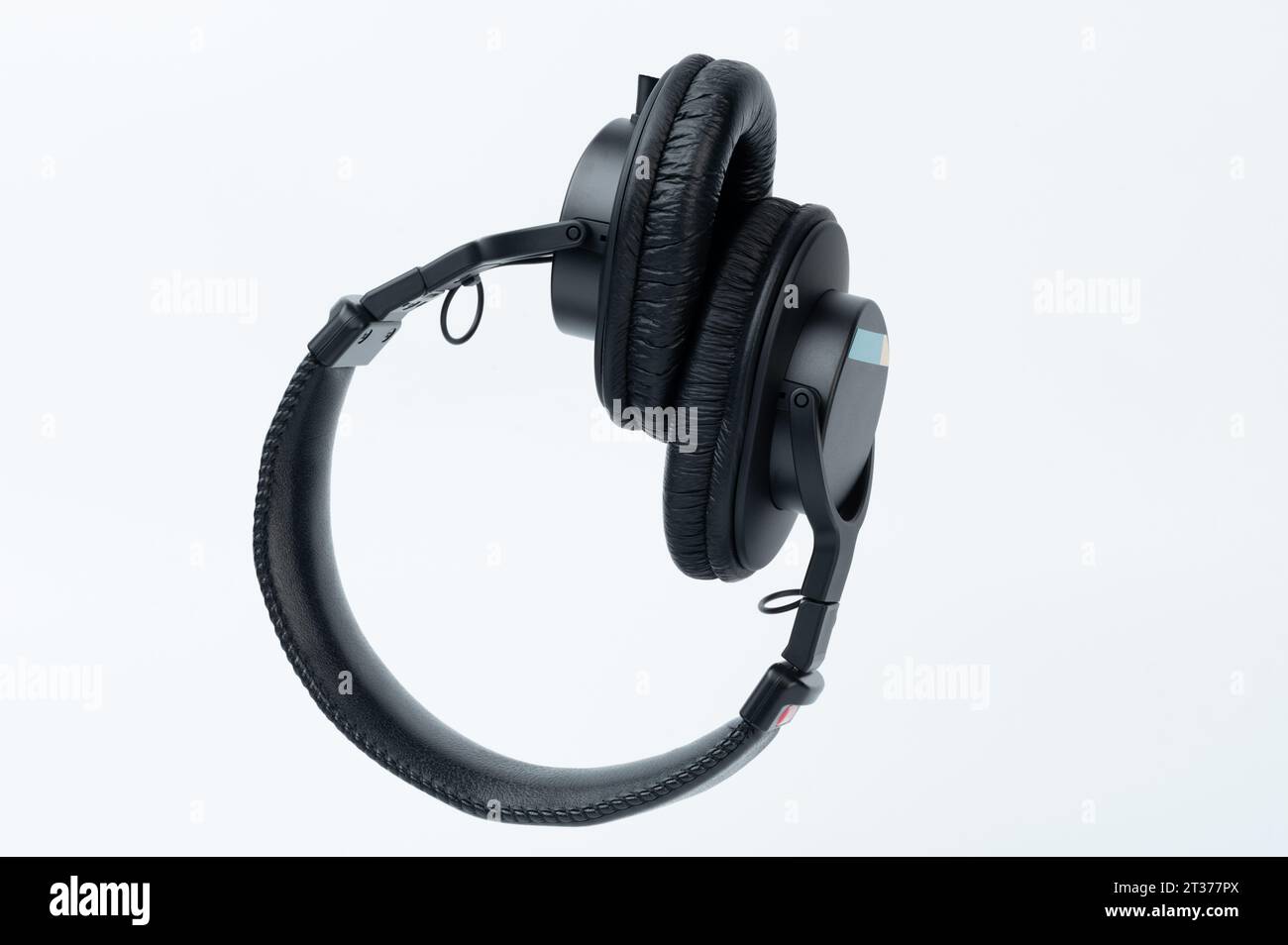 Over ear black studio headphones isolated on studio background Stock