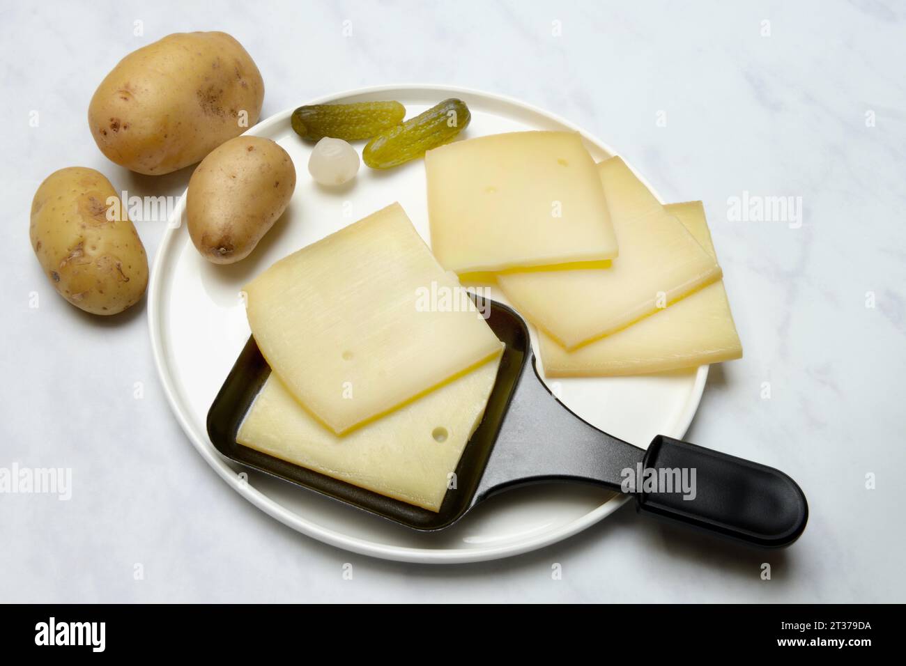 Raclette, cheese slices in raclette pans, Switzerland Stock Photo Alamy