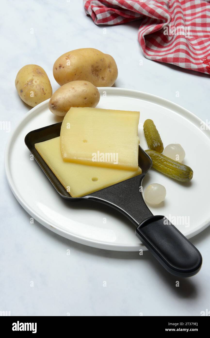Raclette, cheese slices in raclette pans, Switzerland, Europe Stock