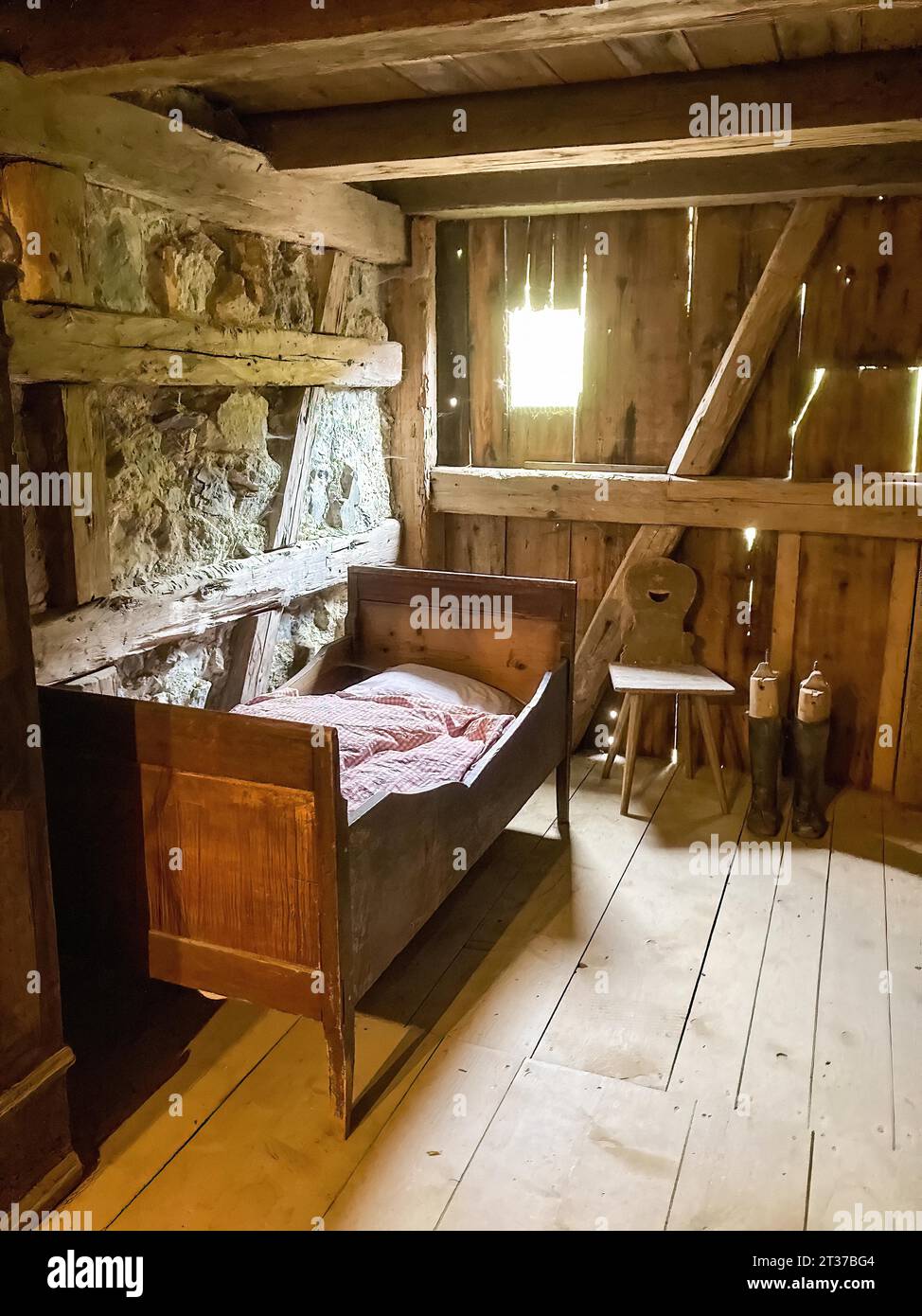 Historic bedroom with single bed for one person on the right chair made
