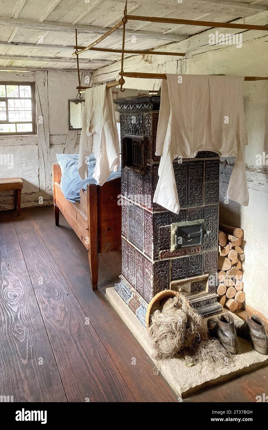 Historic dormitory with tiled stove at the back single bed for one