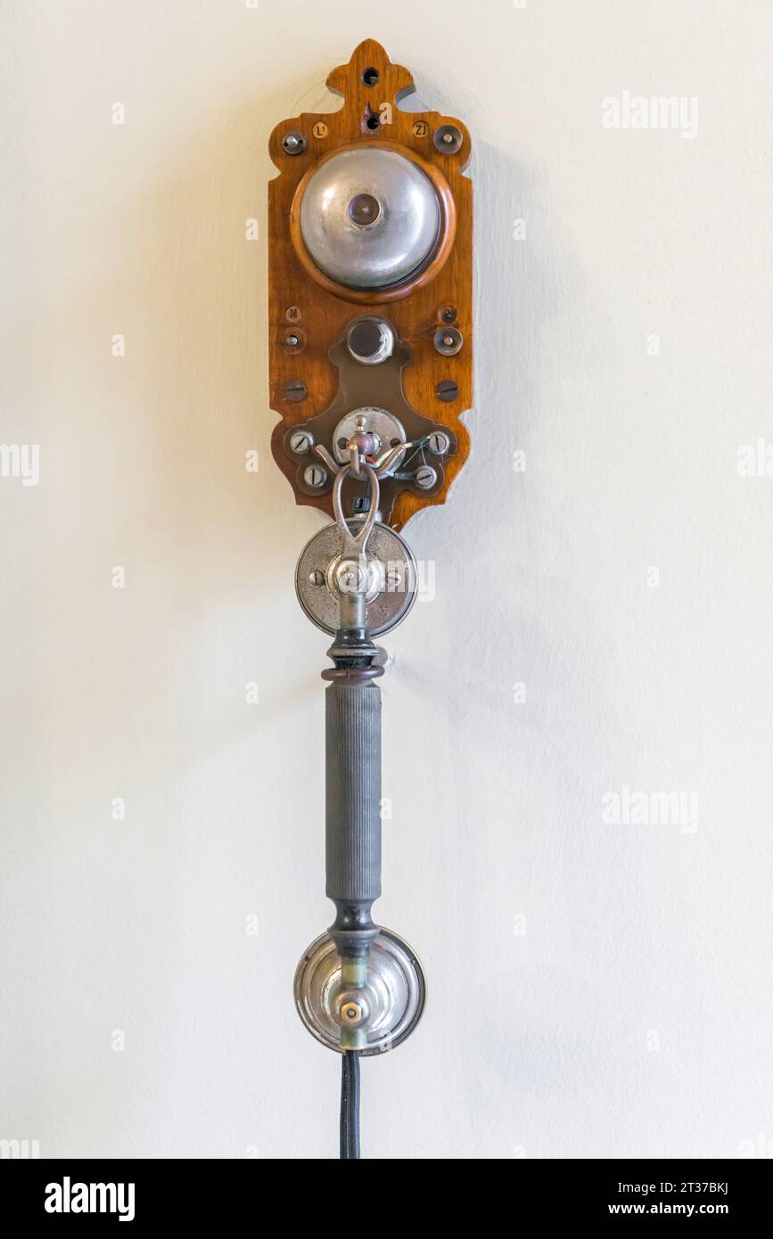 Ancient, antique telephone hanging on a room wall, historic, history, communication Stock Photo