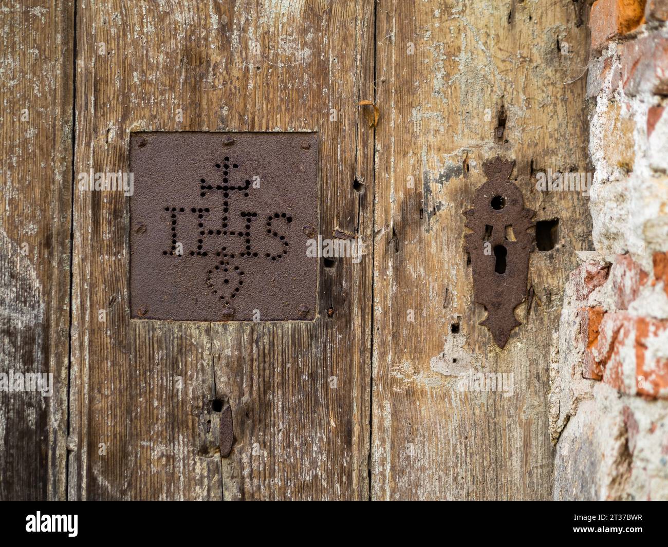 IHS, symbol of the Jesuits, detail of a gate, cemetery near the church of St. Jacob, Leoben, Styria, Austria Stock Photo