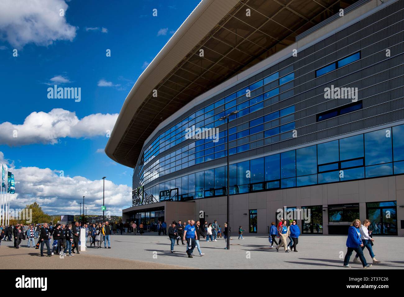 Visitors, fans on their way into the stadium, glass front of the main stand PreZero Arena, Sinsheim, Baden-Wuerttemberg, Germany Stock Photo