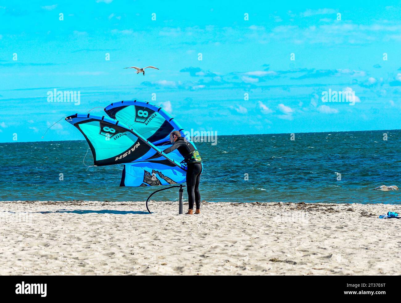 Windsurfing is fun, you have to make sure that all the lines are hooked up right, or you can go windsurfing by just holding on to the Kite it self. Stock Photo