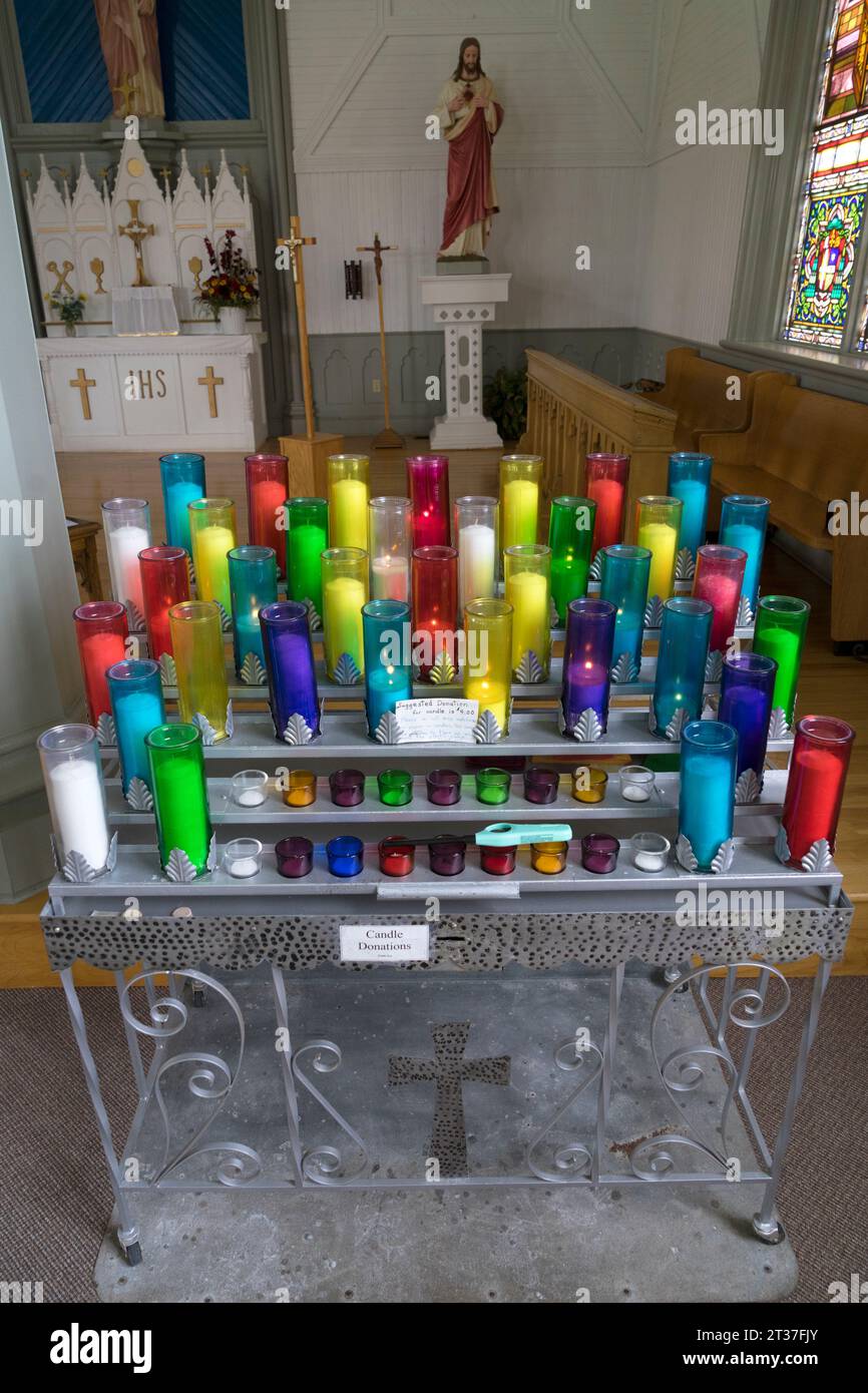 Votive candles in St Augustines Roman Catholic church, South Rustico, Prince Edward Island, Canada Stock Photo