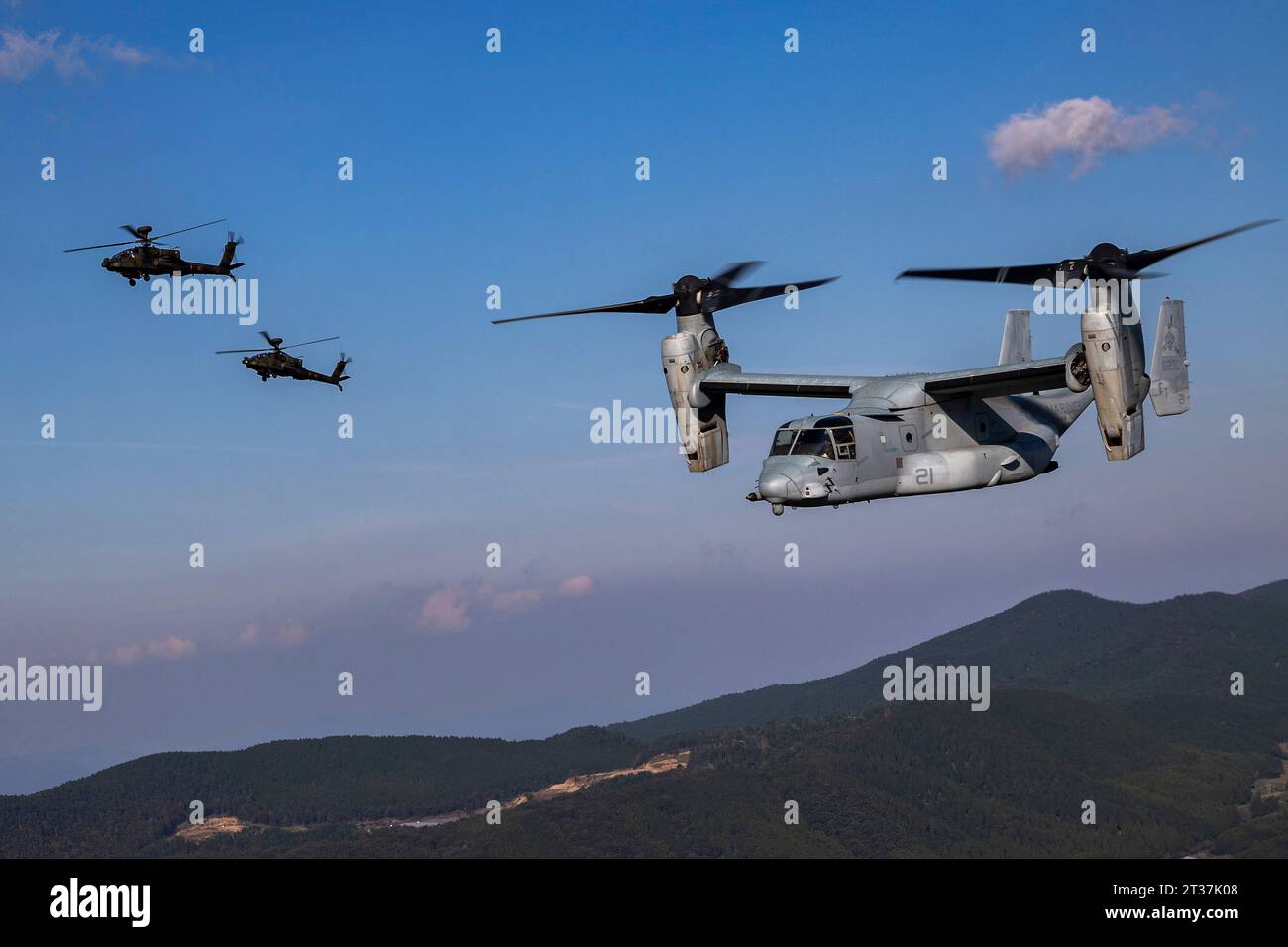 Kumamoto, Japan. 18th Oct, 2023. A U.S. Marines MV-22 Osprey tilt-rotor aircraft assigned to Medium Tiltrotor Squadron 262 conducts a bilateral formation flight alongside Japan Ground Self-Defense Force AH-64 Apache attack helicopters during Resolute Dragon 23 at Japan Ground Self-Defense Force Jumonjibaru Proving Grounds, October 19, 2023 in Kumamoto, Kyushu, Japan. Credit: Cpl. Kyle Chan/U.S. Marine Corps/Alamy Live News Stock Photo