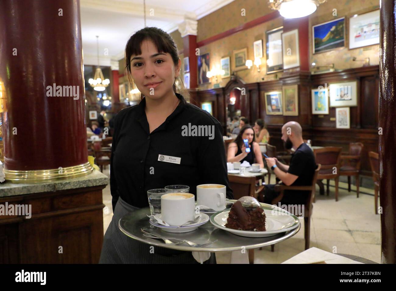 A waitress with a tray of coffees and dessert working in Cafe Tortoni. Buenos Aires.Argentina Stock Photo