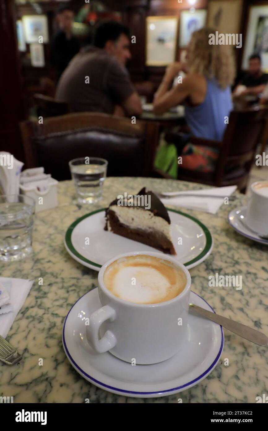 A cafe con leche coffee with milk and a piece of chocolate cake served in cafe Tortoni. Buenos Aires.Argentina Stock Photo