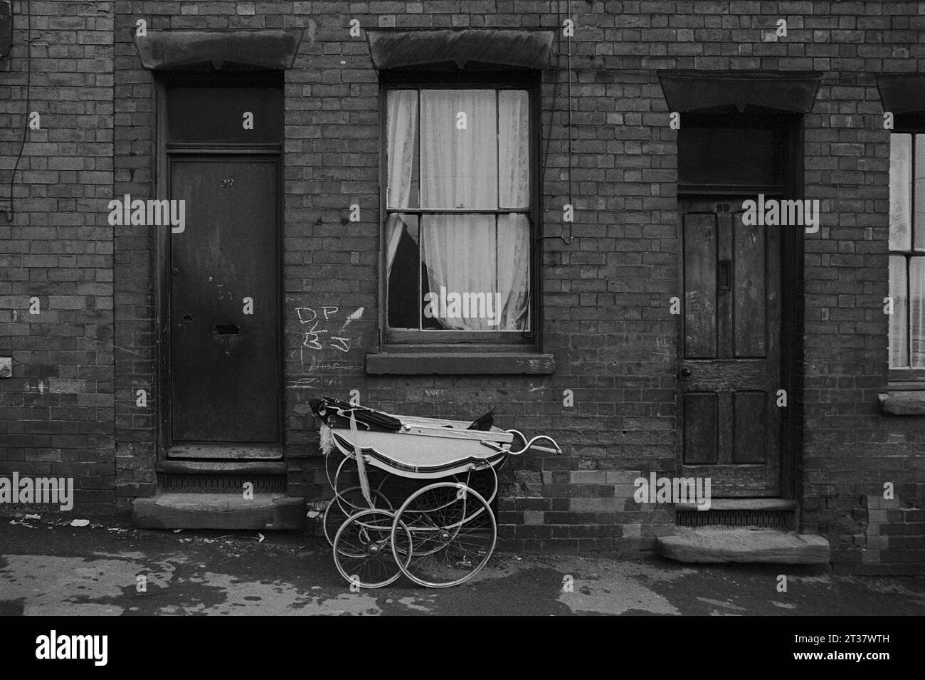 97 Pym Street with a Silver Cross pram parked outside the front door during the slum clearance and demolition of St Ann's, Nottingham. 1969-1972 Stock Photo