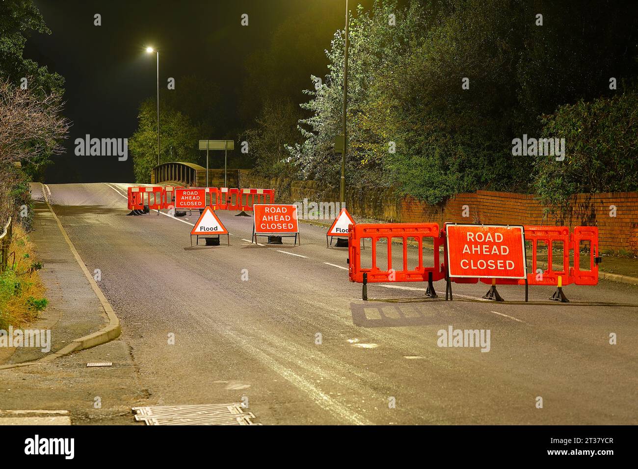 Road Closed signs and barriers  on Lock Lane in Castleford,West Yorkshire,UK to prevent motorists driving along a flooded road during Storm Babet Stock Photo