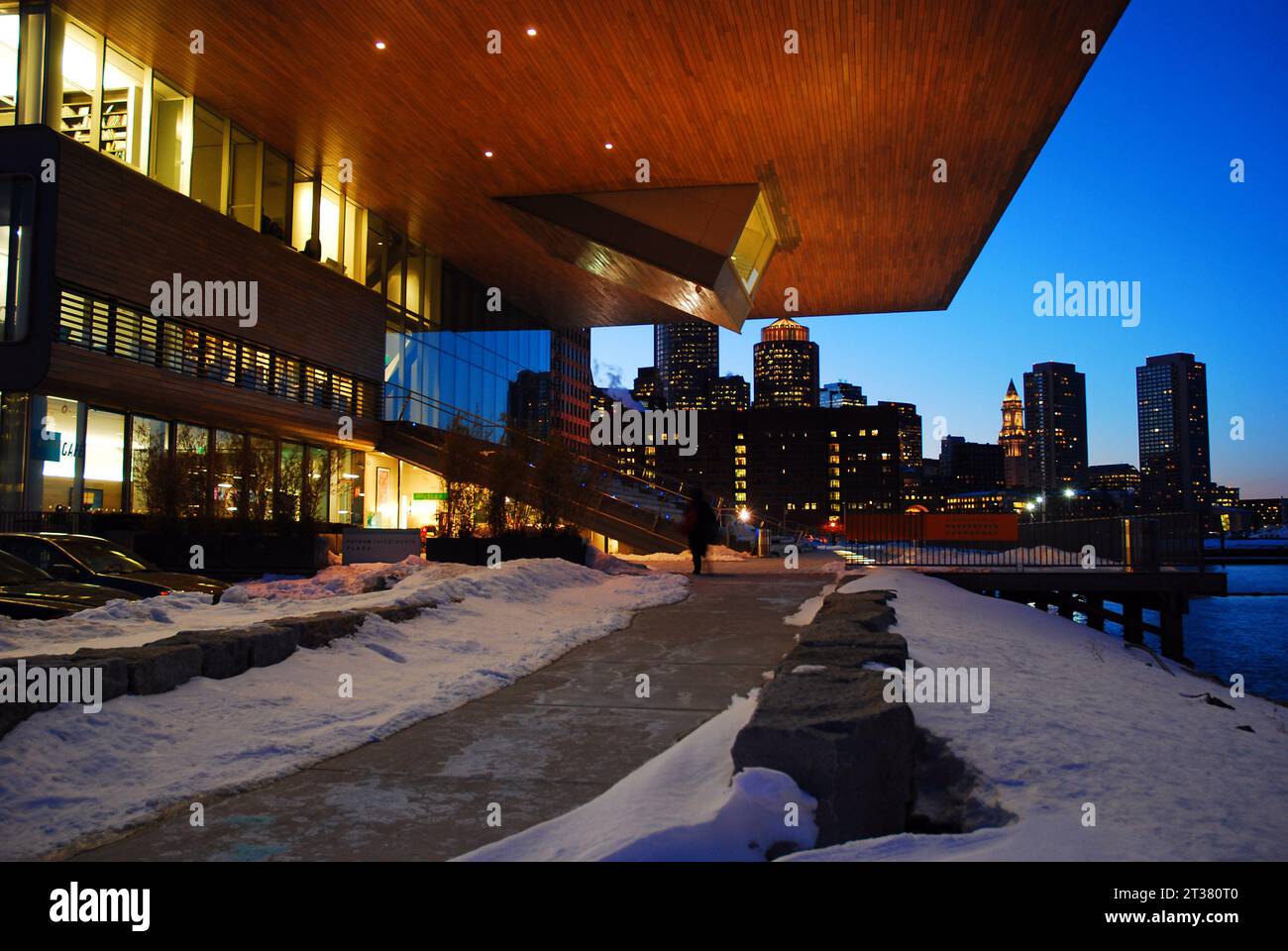 the city skyline of Boston rises behind the facade of the Contemporary