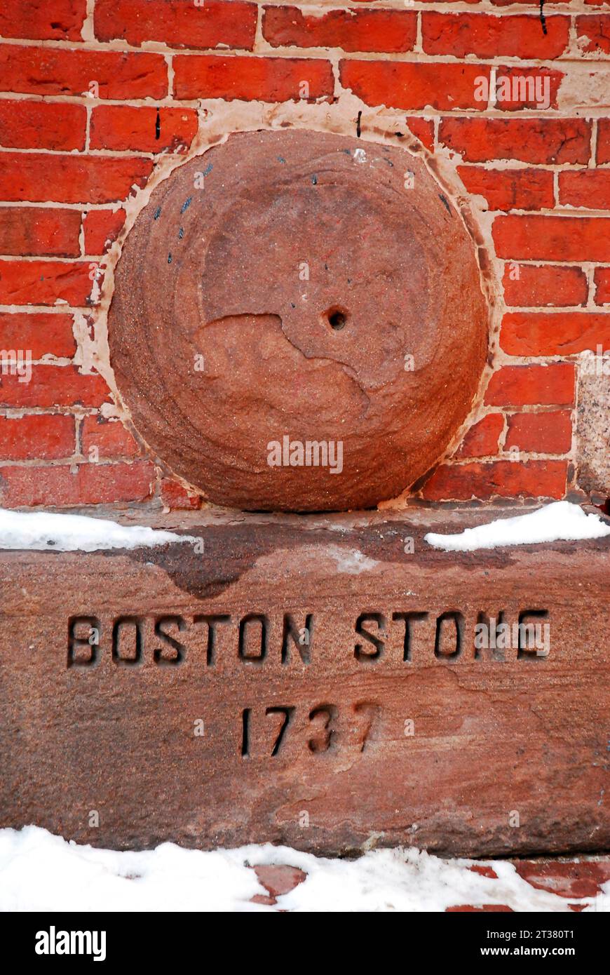 The Boston Stone is embedded in a brick wall and was used to measure distance within the city and in the neighboring towns Stock Photo