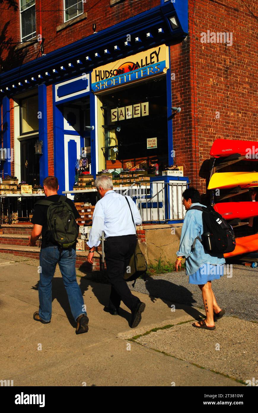 A Group Of People Walk Though The Downtown Of The Small Town Of Cold