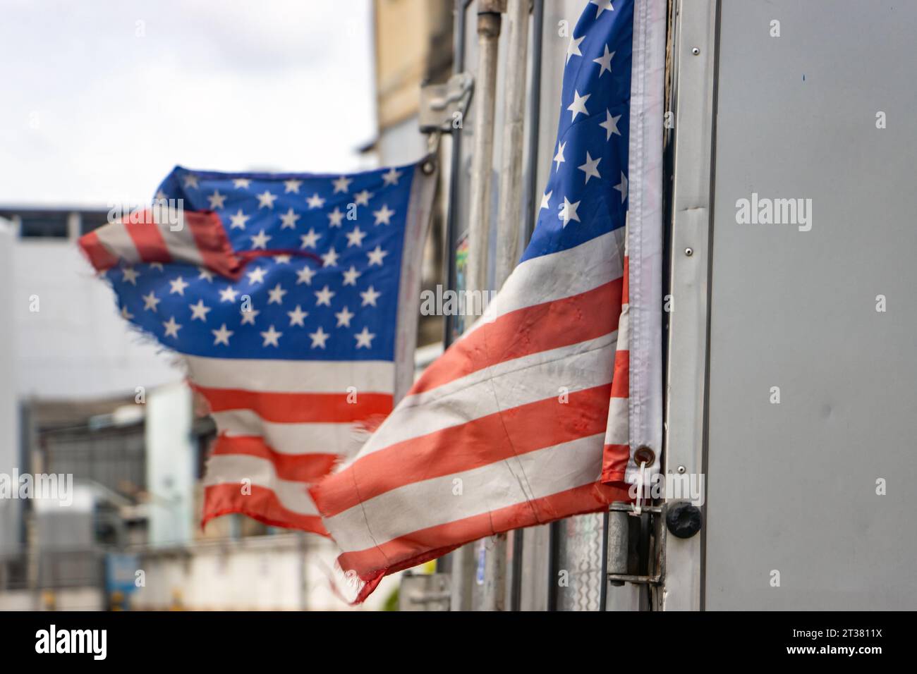 Tattered US flags fly on a moving truck Stock Photo Alamy